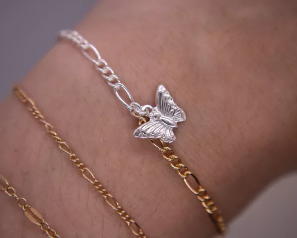Dual tone figaro bracelet with butterfly