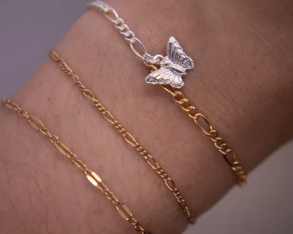 Dual tone figaro bracelet with butterfly